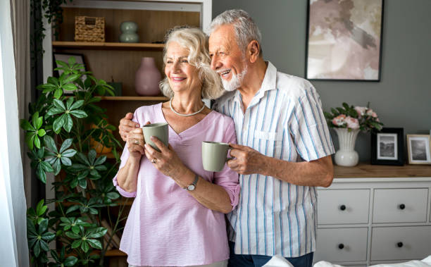 istock Senior couple drinking coffee together at home 2169030573