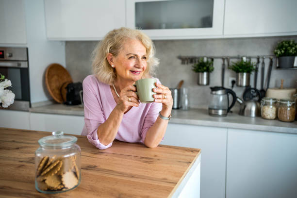 istock Senior woman drinking first morning coffee 2169030678
