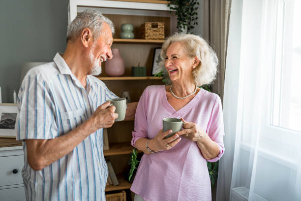 istock Senior couple drinking coffee together at home 2169031272