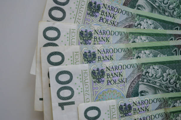 Polish zloty banknotes displayed on a white background, showcasing the national currency of Poland. The image emphasizes the financial and economic aspects of Polish money, highlighting its role in transactions, savings, and financial planning.