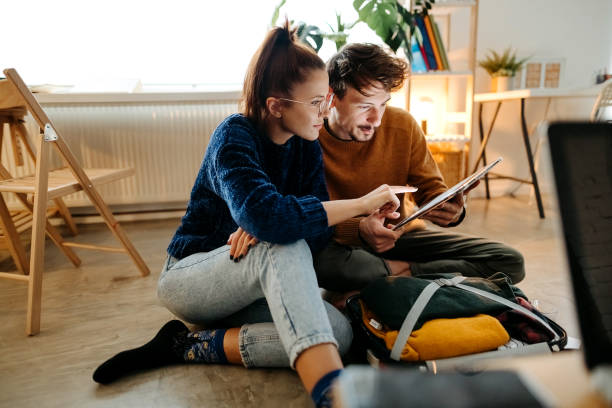 Couple planning vacation trip and searching information on tablet