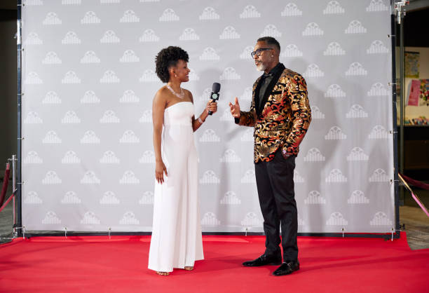 Celebrity giving interview to media host at event