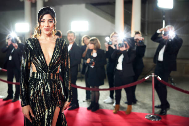 istock Smiling female celebrity walking on red carpet 2169043002
