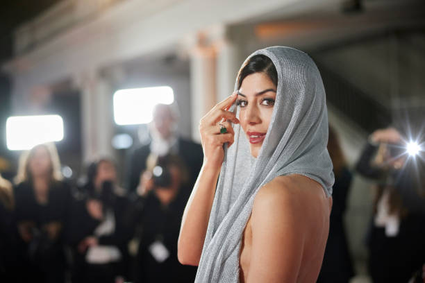 Celebrity posing for paparazzi on red carpet