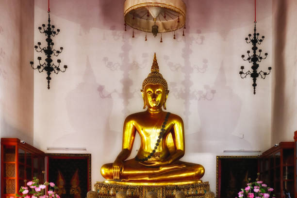 istock A golden Buddha statue in a temple. 2169043456
