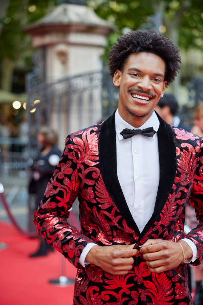 Smiling man in designer suit at red carpet event