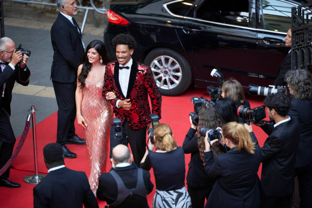 istock Smiling celebrities walking together on red carpet 2169043689