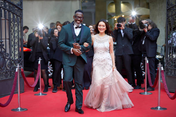 istock Celebrities walking with arm in arm at event 2169043735