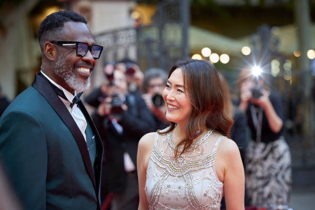 Happy celebrities in designer clothes at event