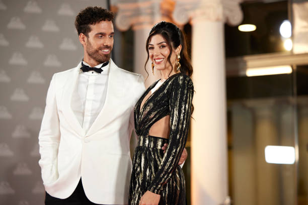 istock Smiling celebrity couple at red carpet event 2169043875