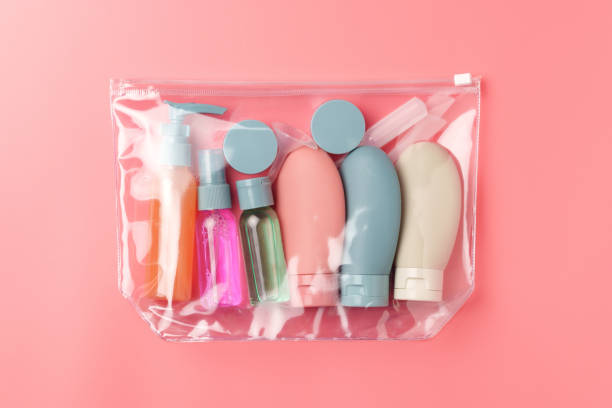istock Clear Plastic Bag Containing Travel-Sized Toiletries on Pink Background 2169045042