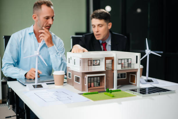 istock Meeting of architects, designers, and developers creating innovative, sustainable housing projects using building models and digital tools. 2169045239