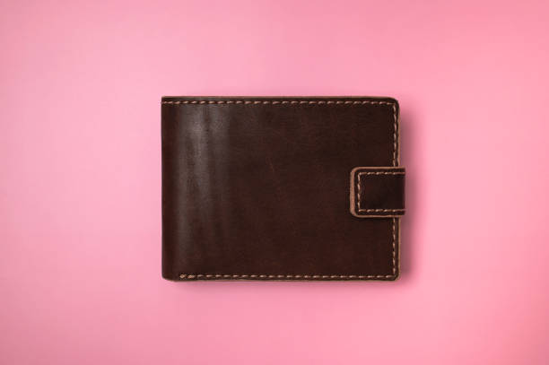 istock Brown leather billfold wallet on pink background, top view flat lay. Minimalistic concept of shopping, online payment. Stylish unisex wallet. Business and Finance 2169045338