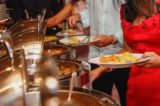 Unrecognizable guests taking buffet food
