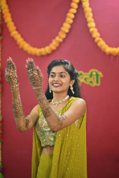 istock Bride in her modern traditional attire displaying her Mehandi 2169051471