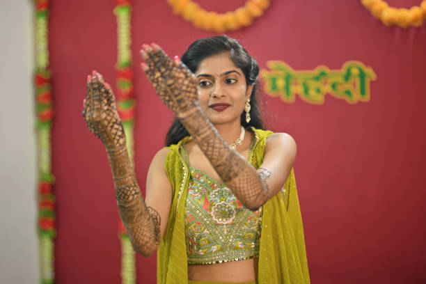 istock Bride in her modern traditional attire displaying her Mehandi 2169051554
