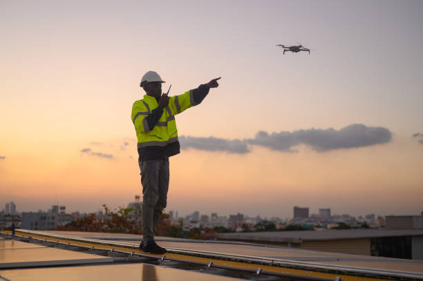 istock Male engineer works installing solar panels on the roof. Engineer or worker working on solar panels or photovoltaic cells on the roof of a business building. 2169053215
