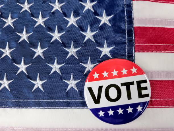 istock Campaign Vote Button On American Flag 2169060132