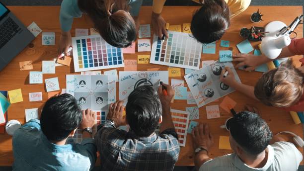 istock Interior designer looking at logo while choosing color palettes. Symposium. 2169060546