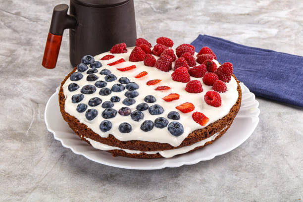 Fruit juicy cream cake with biscuit, cream cheese, strawberries, blueberries and whipped cream. Refreshing dessert