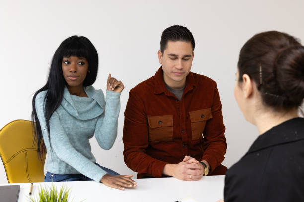 istock Young couple discussing with financial advisor at office desk 2169064736