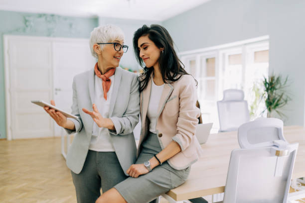 istock Two businesswoman talking at modern office 2169065336