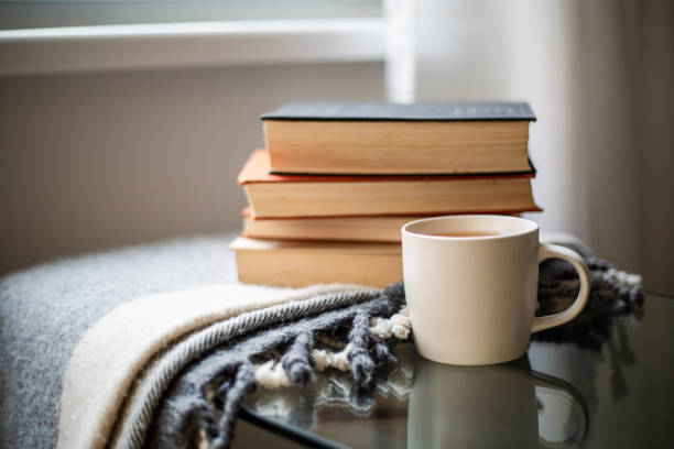 Books with a cup of tea and cozy blanket