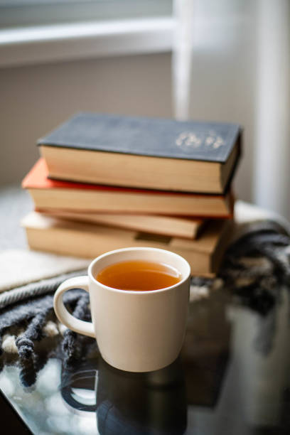 istock Cup of tea with books and plaid blanket 2169067144