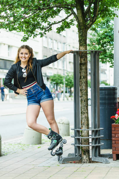 istock Young woman riding roller skates 2169068902