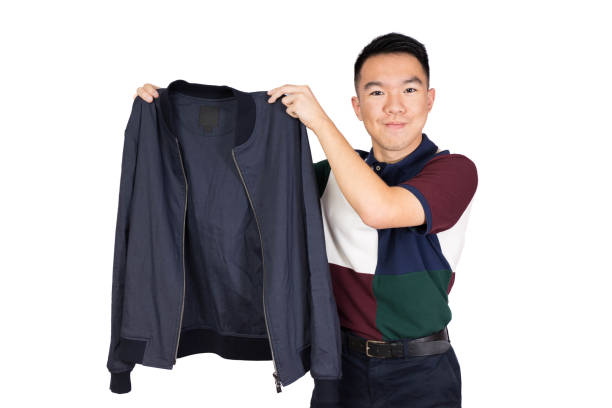 istock A young man happily holding up a bomber jacket isolated portrait 2169071147