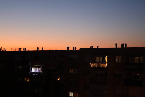 istock Charming sunset over city apartments with glowing balcony lights 2169072900