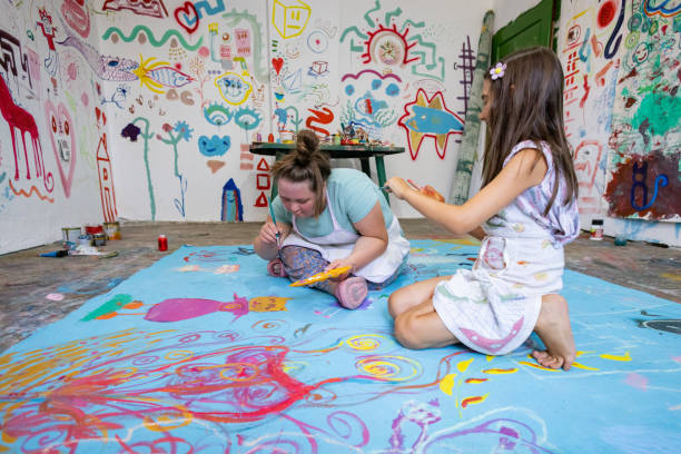 istock Two Sisters Having Fun Painting 2169074715