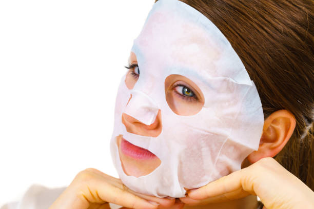 istock Woman applying sheet mask on face 2169074926