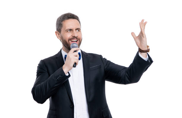 istock cheerful speaker man with microphone. man speaker wear tuxedo in studio. speaker man speaking 2169077293