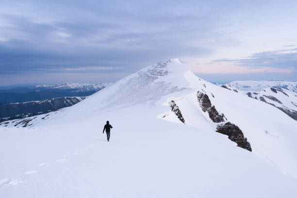 istock Man in winter mountain hike 2169082903