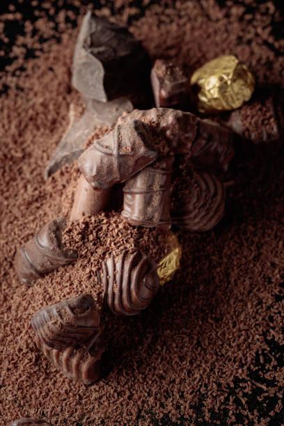 Chocolate candies on a black background sprinkled with chocolate chips.
