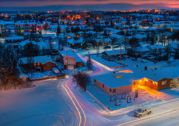 I captured this winter night scene in Yellowknife, Canada. The cottages blanketed in snow create a magical view of a winter wonderland. The warm lights from the houses and the glowing trails of car lights create a vibrant contrast against the quiet, snowy landscape.