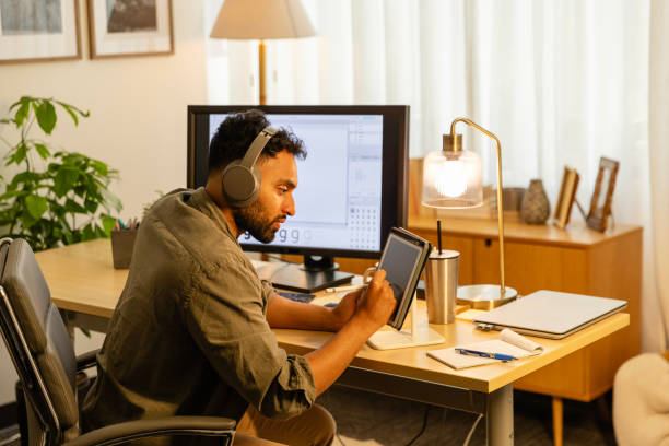 istock Male design professional uses pen and tablet for work 2169088381