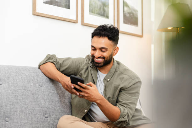 istock Male creative answers text messages on smart phone 2169088406