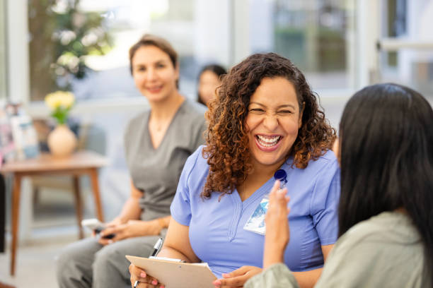 istock Nurse looks up from phone when colleague laughs with patient 2169088921