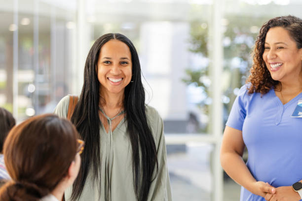 istock Female patient smiles at unrecognizable clinic receptionist 2169088925