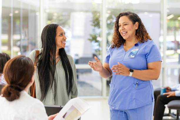 istock Female nurse gestures while helping woman with registration 2169088928