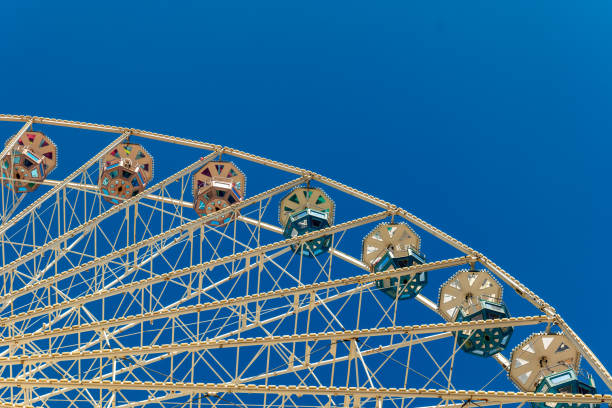 a large white and blue ferris wheel with many colorful cabins