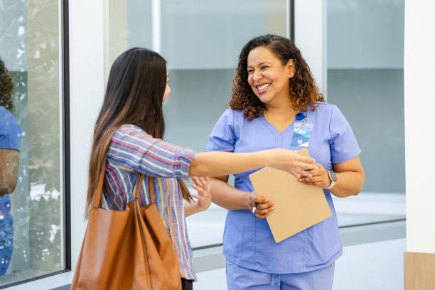 istock Nurse laughs as female patient describes symptoms 2169089108