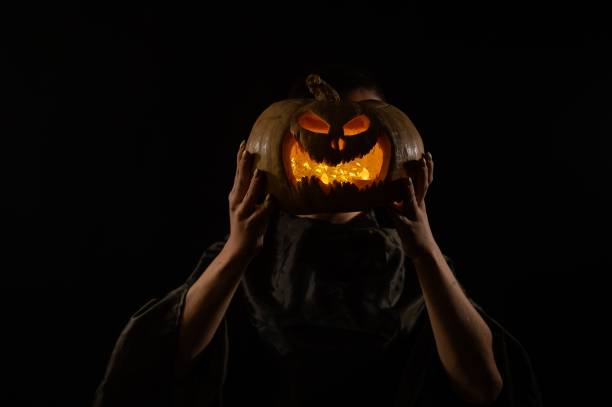 istock Pumpkin jack o lantern instead of a woman's head. Halloween 2169100937