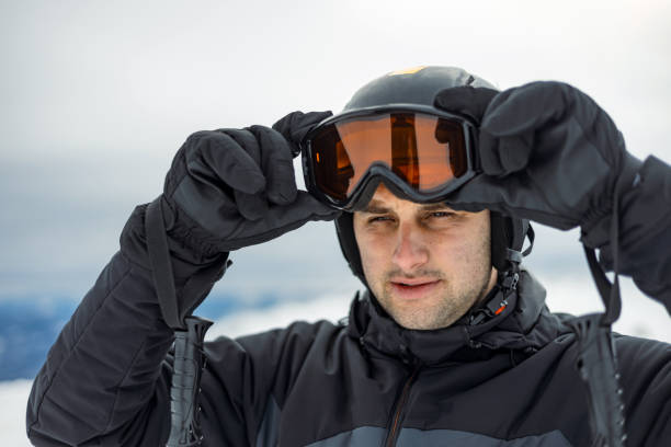 istock Man adjusting ski goggles on snowy mountain. 2169102500