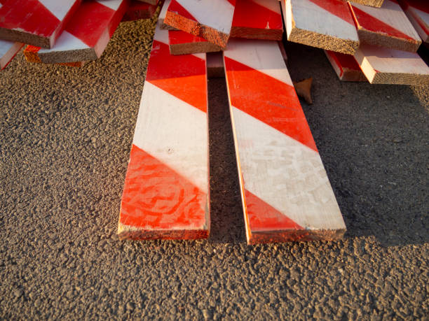 Large Stack of Red and White Striped Construction Wood Slats