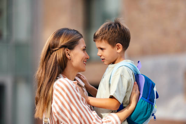 istock Smiling Mother and Son Embrace Before First School Day 2169109292