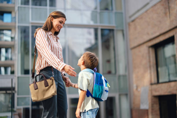 istock Back to School Mom and Son Outside Elementary School 2169109299