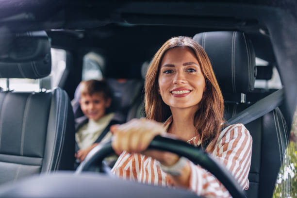 istock Smiling Mother Driving Son to Elementary School 2169109475